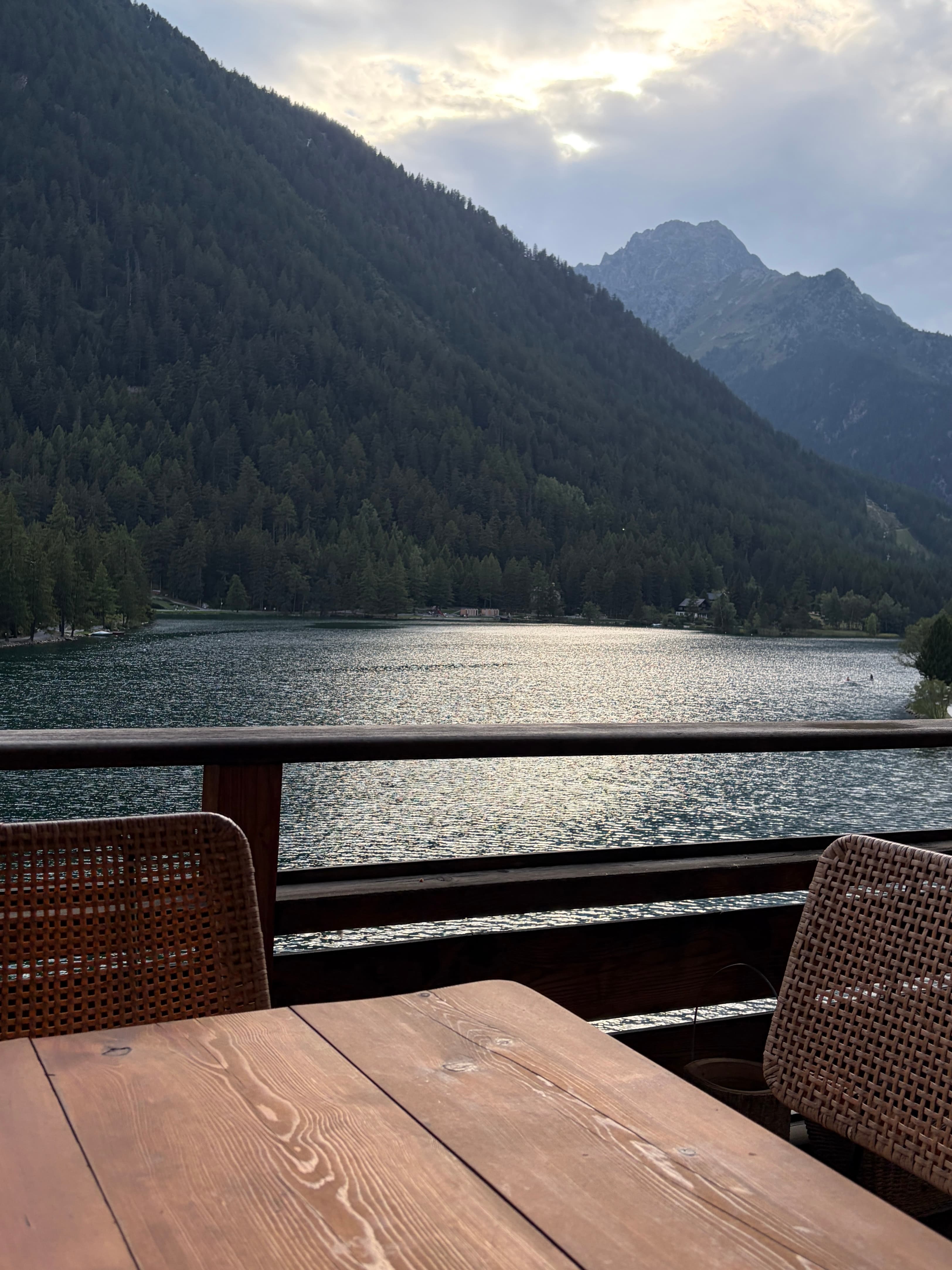 The Alpine Nest chalet terrace overlooking the lake and mountains of Champex-Lac in the Swiss Alps